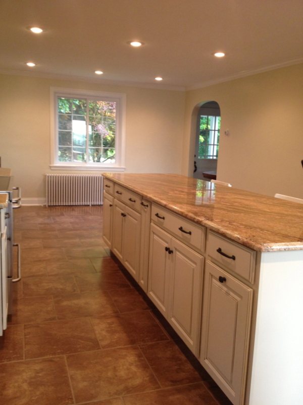 Long cream kitchen island with drawers and cabinets along its full length